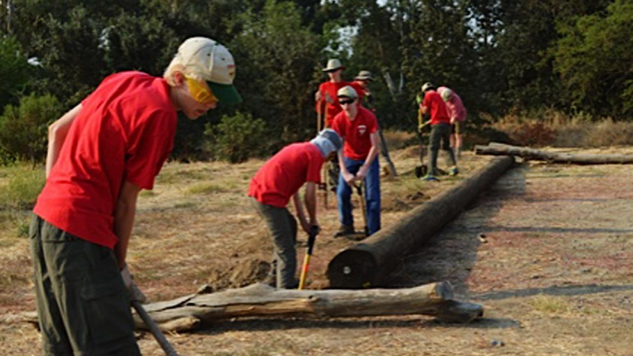 Scouts from Troop 111 work to install posts along the reserve to  protect the sensitive landscape at UC Davis Putah Creek Riparian Reserve.