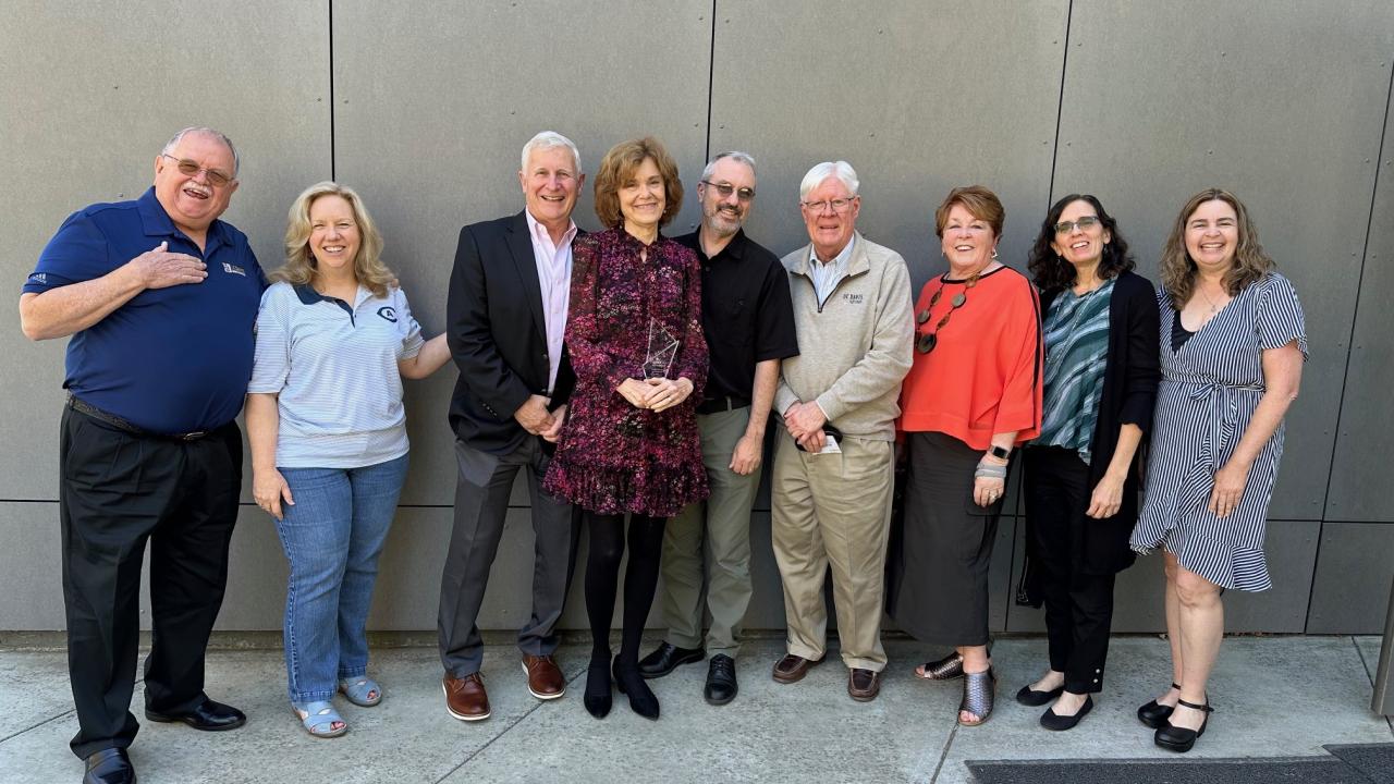 Group of people, including Arboretum staff and donors, stand posing for a picture